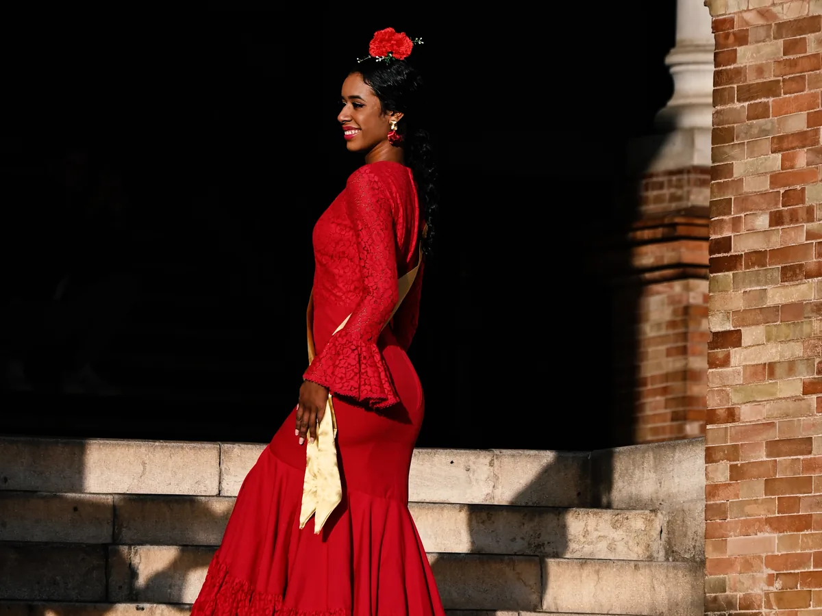A flamenco dancer in a ruffled dress mid-movement